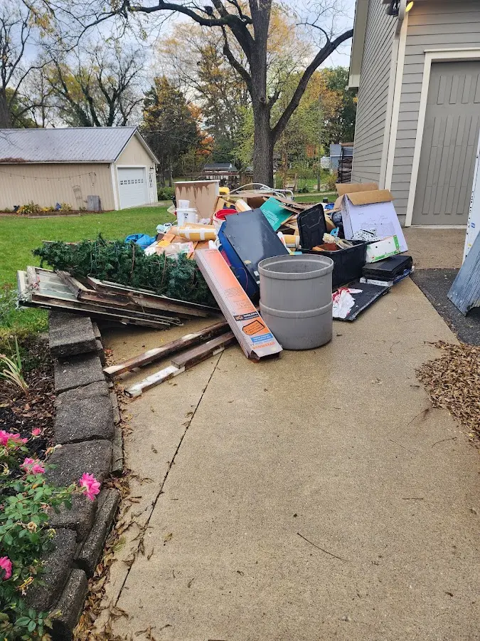 Dumpster being loaded with debris for 12 Yard Dumpster Rental in Bee Cave